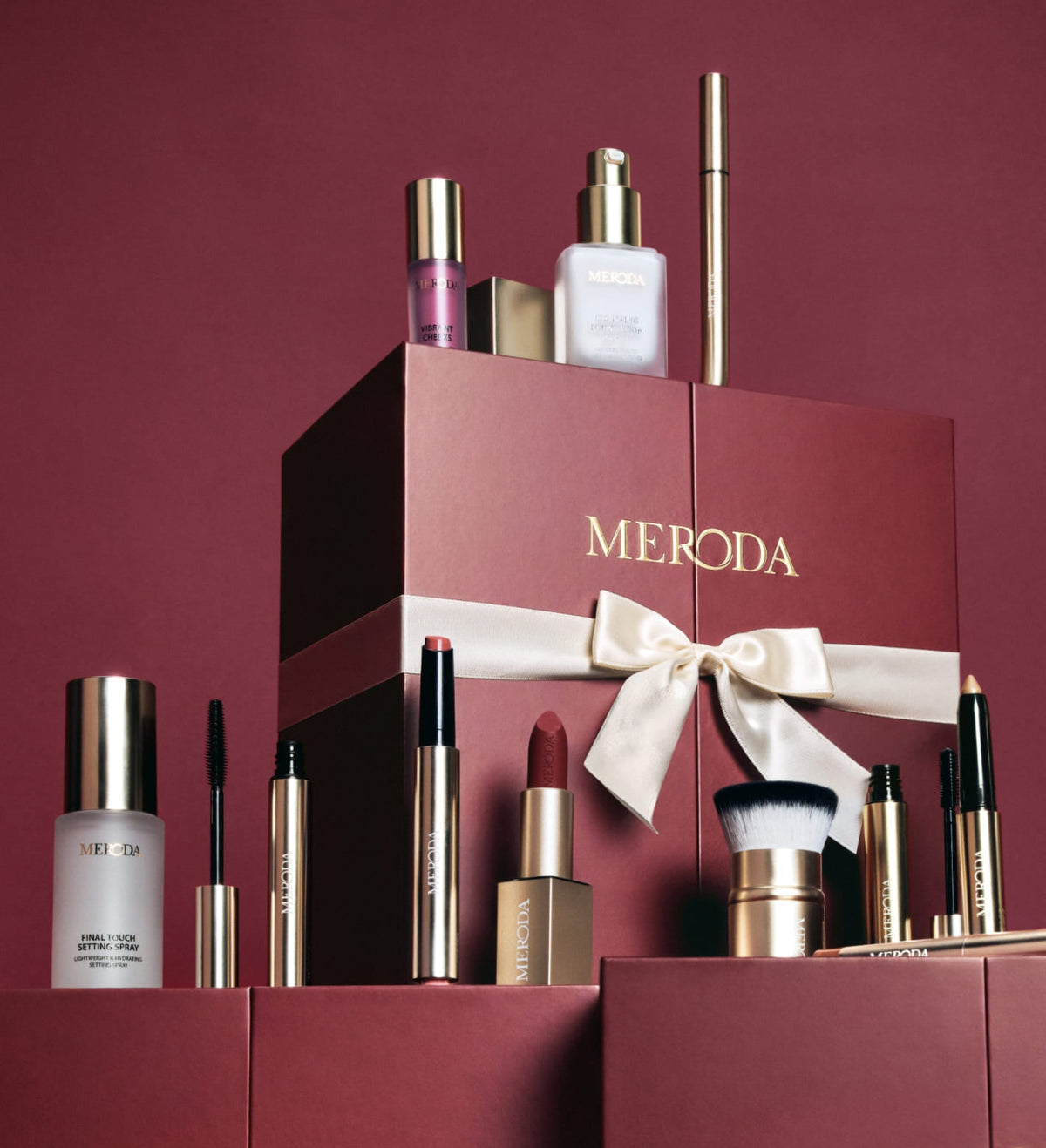 Advent Calendar - 12 Days of Effortless Beauty displayed in burgundy packaging with a gold ribbon and makeup products.