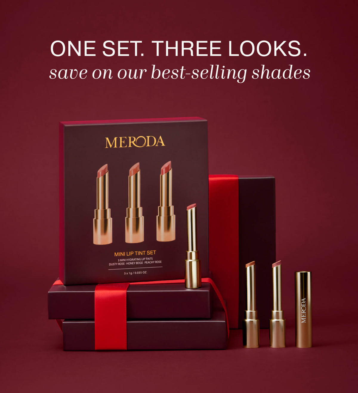 Mini Lip Tint Trio featuring three hydrating lip tints in gold packaging alongside a gift box with red ribbon.