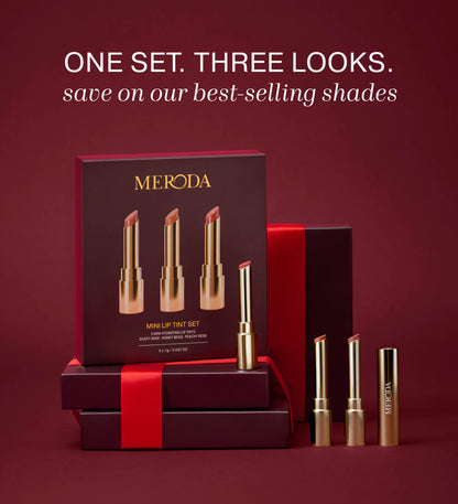 Mini Lip Tint Trio featuring three hydrating lip tints in gold packaging alongside a gift box with red ribbon.